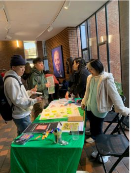 Image of four people standing around a table looking at various resources