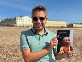 Dr Feras Alkabani holds a copy of his latest book, Richard Burton, T.E. Lawrence and the Culture of Homoerotic Desire