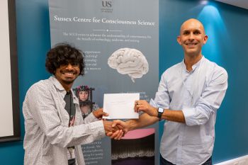 Prof Anil Seth awarding our winning PhD student, Yesesvi Konakanchi with £100 for the poster competition.