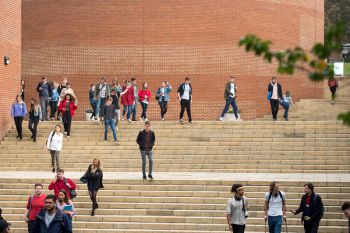 People walking up and down steps on campus.