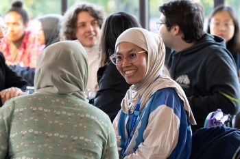 International students chatting cheerfully at the Welcome event