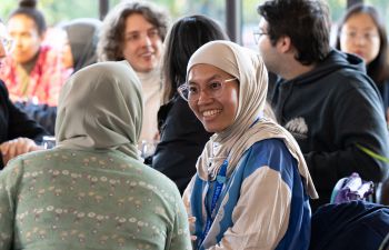 International students chatting cheerfully at the Welcome event