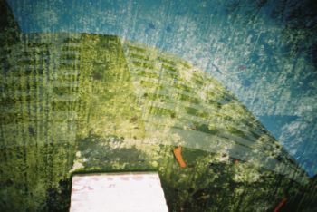 Abstract green curved roof against blue background