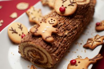 A Yule log with biscuits on top in a festive and warming image