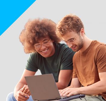 Two students looking at a laptop