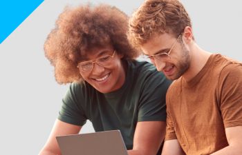 Two students looking at a laptop