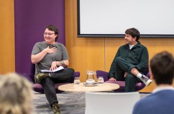 James Ward-Lee and Fox Fisher seated in front of an audience