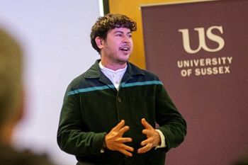 Fox Fisher standing in front of a screen