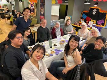 IISMA students enjoying coffee and cake in cafe decorated for Dia de Muertos