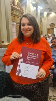 Mia Difolco holding her Apprentice Graduation certificate