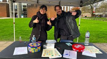 Augusta and Glebs at the kindness bingo stand.