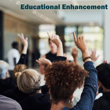 A group of university students, from behind, with their hands up, implying that they are voting on something. There is a watermark of Educational Enhancement at the top.