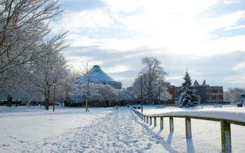 The Meeting House stands out in the background surrounded by the fields around Library covered in snow