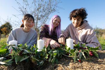 University of Sussex students Ami Kudo, Blu Baker and Aron Stornaiuolo being festively creative with foliage growing on our beautiful South Downs campus as part of their Forest Food Garden module