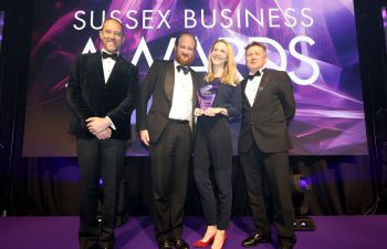 The winners stood on stage in front of a Sussex Business Awards backdrop