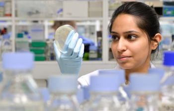 Student looks at petri dish