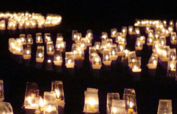 A photo of lit candles against a black background