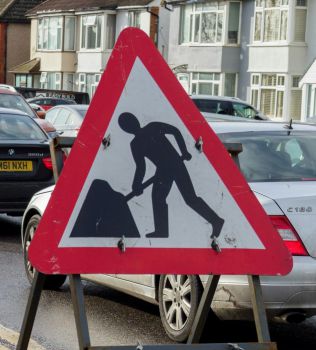 A triangular roadworks sign