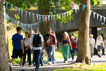 Students walking on campus on a sunny day