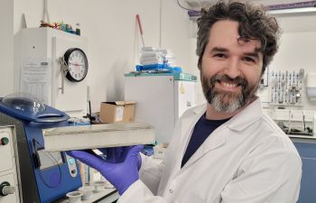 scientist holding block of material used to build wind turbine blades