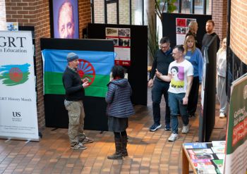 Staff and students explore the photo exhibition at the Attenborough Centre