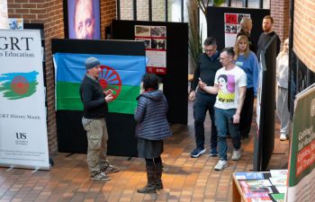 Staff and students explore the photo exhibition at the Attenborough Centre