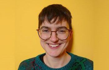 Simone Webb pictured in front of a yellow background