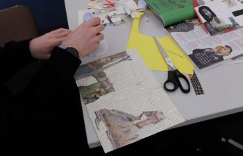 Person cutting magazines for collage