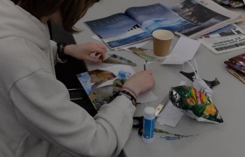 Person cutting pictures for collage