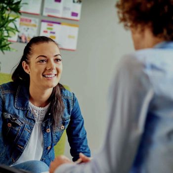 Course image of a woman speaking to a man in an office setting.