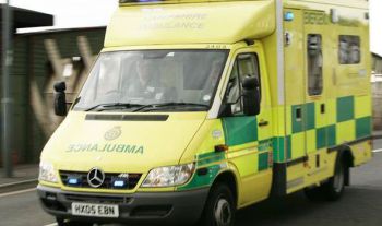 An ambulance travelling down a street