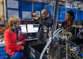 Baroness Jones and Bella Sankey are shown around the quantum lab by Professor Winfried Hensinger