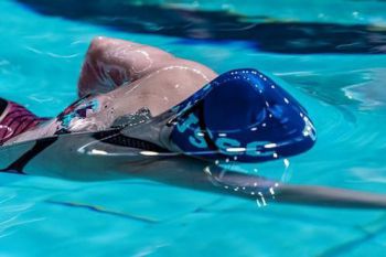 Swimmer with a Sussex swimming cap on