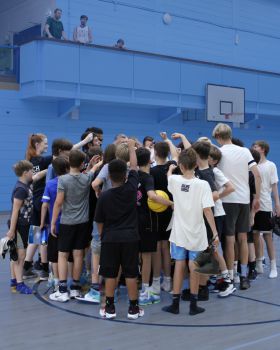 a group of children in a huddle having a team talk