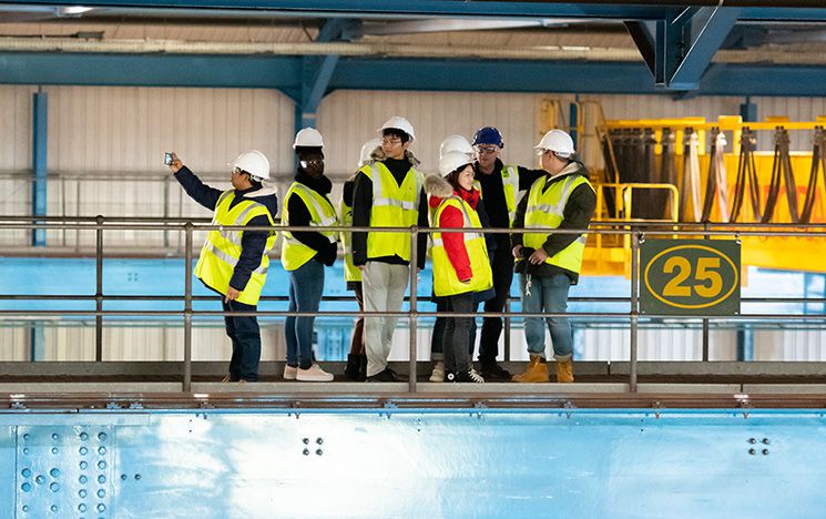 students in high vis at a factory