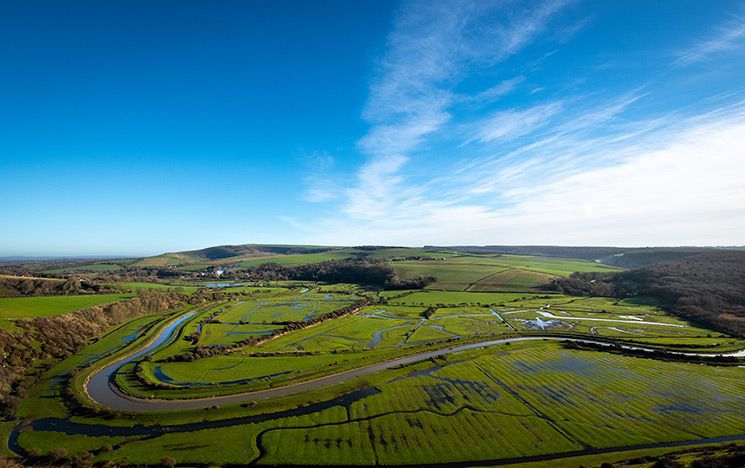 Cuckmere landscape in East Sussex with river, fields and sky