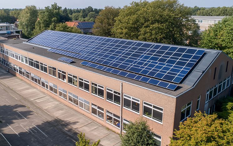 An aerial view of a building with solar panels