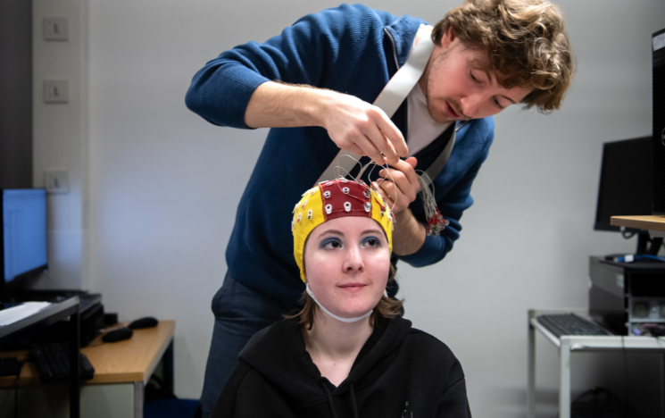 Student being fitted with an EEG cap for a brain lab experiment