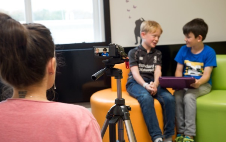 two young children being observed on camera whilst they chat to each other