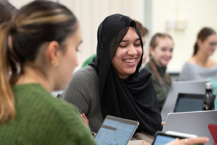 two students with laptops