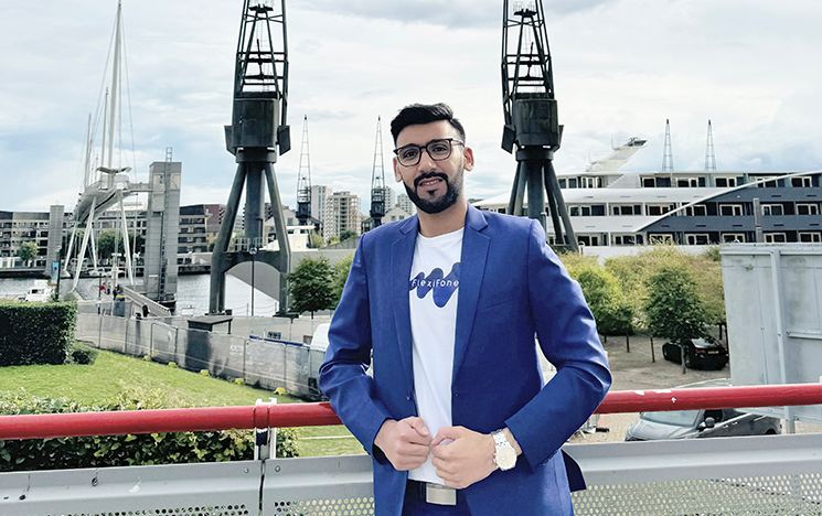 Sarthak Sethi standing in front of buildings and two metal structures.