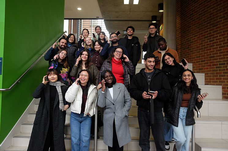 The call campaign team - a group of students smiling and holding mobile phones