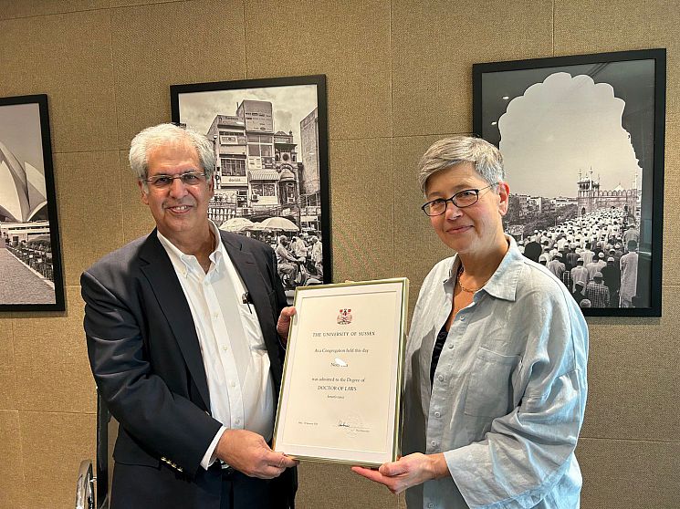 Noel Tata and Vice Chancellor Sasha Roseneil, holding Noel's University of Sussex Doctor of Laws degree certificate