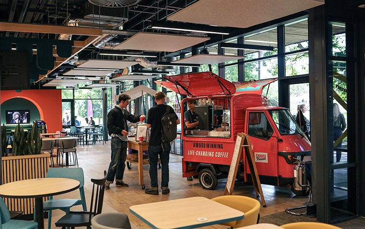 Students ordering coffee at the Eat Central tuk tuk