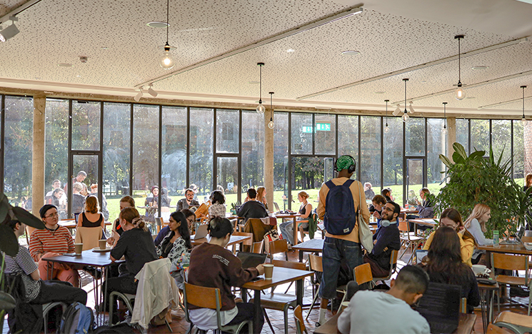 Students sitting at tables inside the attenborough centre cafe