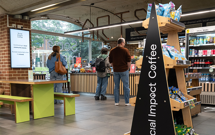 The interior of Arts Piazza. Three people stand at the counter being served.