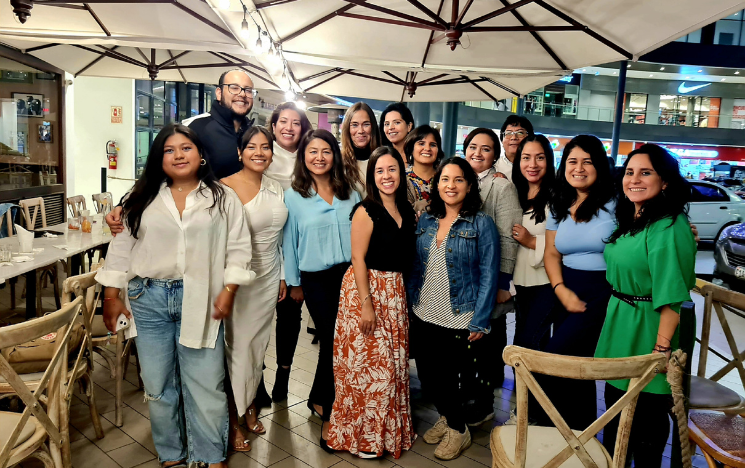 A group of alumni standing in a group outside a restaurant in Lima, Peru