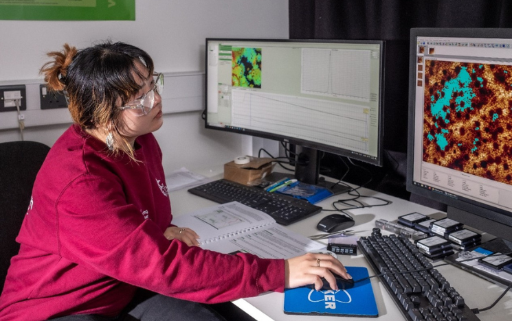 Huyen Le sat at a computer desk at Loughborough University, working on her research.