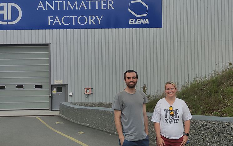 Alberto Jesús Uribe Jiménez and April Cridland at CERN, standing outside the Antimatter factory
