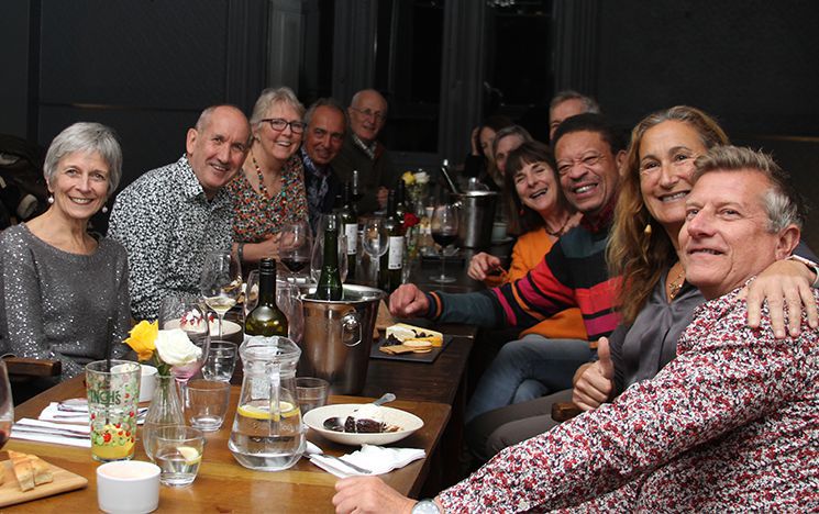 A group of Sussex alumni sat round a table enjoying their reunion